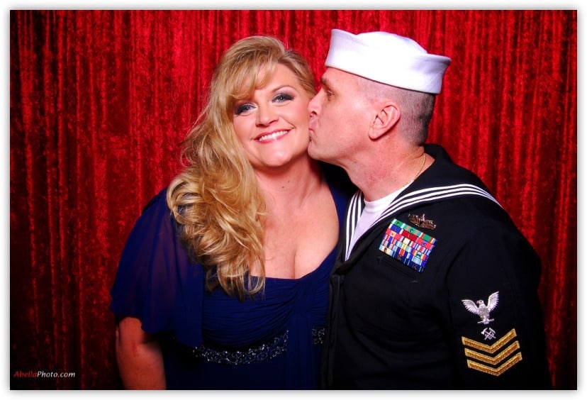 Sailor and his wife kissing in the photo booth Client Testimonials