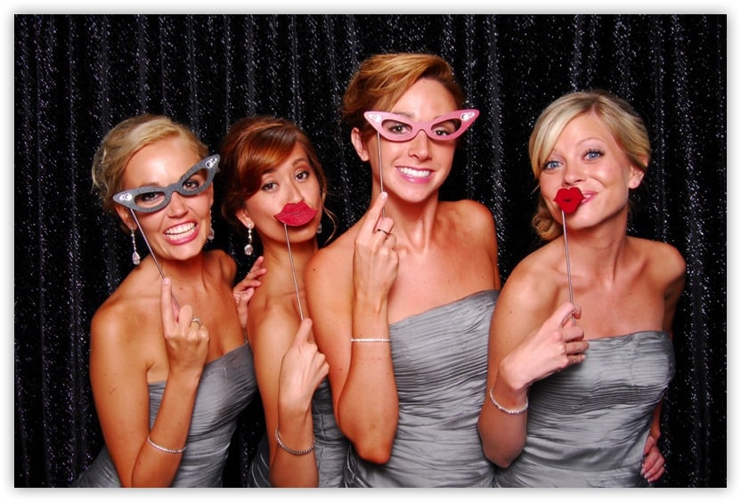 four bridesmaids striking a pose with props on a stick Client Testimonials
