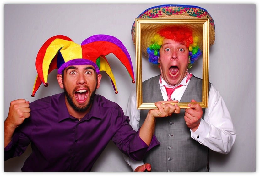 Two men clowning around in a photo booth