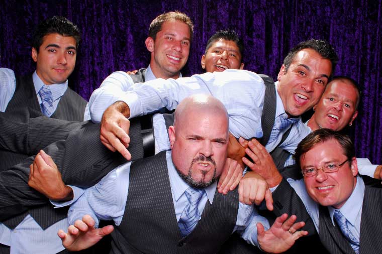 Excited groomsmen hoisting the groom at a wedding