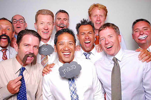 nine men from Team Mojo posing in a photo booth