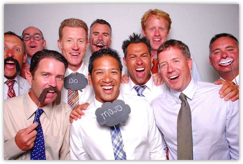 Corporate executives letting lose in the photo booth