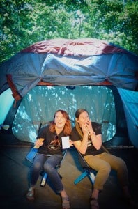 two women acting scared in a tent