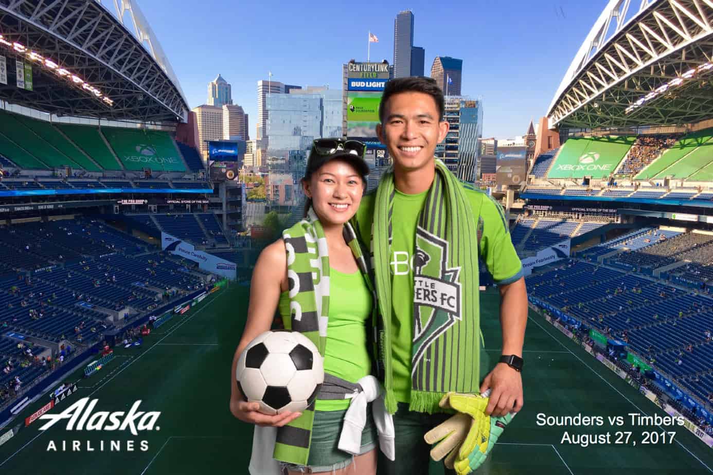 Man and a Women posing at Century Link field in Seattle during a soccer match.