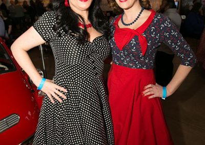 Two women dressed in 50s style dresses